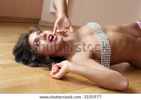 Sexy woman lies on a wood floor.