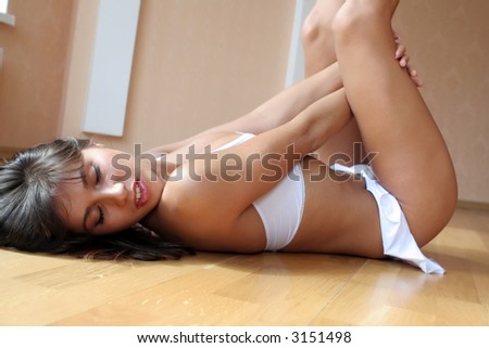 Sexy woman lies on a wood floor.