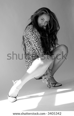 Art model in sensual pose. Black and white photo.