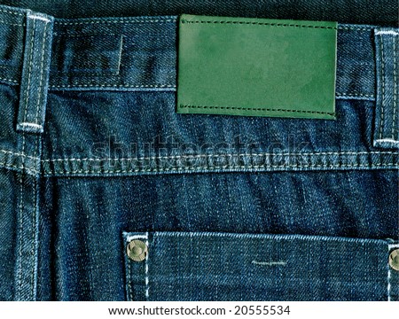 Fragment of jeans with pure green label for your text.