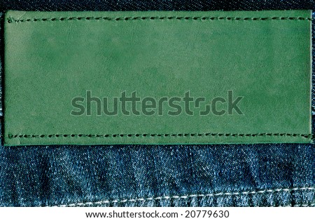 Fragment of jeans with pure green label for your text.