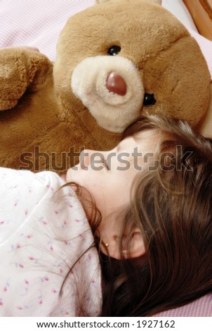little girl sleeping with a plush bear