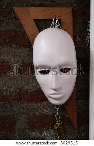 a mask and a ruler hanged at an artist atelier