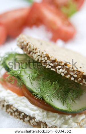 cucumber,tomato, rosemary and cheese sandwich still life with blurry background