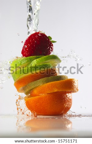 water splashing over sliced fruits