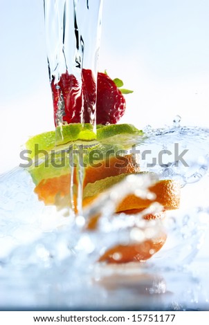 water splashing over sliced fruits