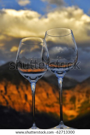 Wine glasses ready to toast while viewing an incredible sunset on Ajax and Telluride peak in Telluride Colorado.