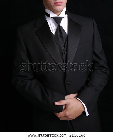 Man wearing black tuxedo, dress for special occassion.
