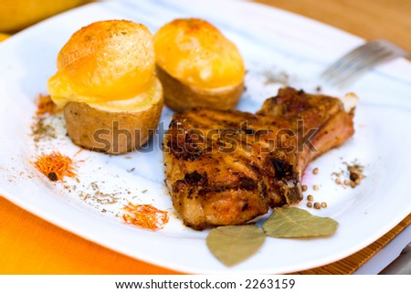 Baked Pork ribs and potato baked with cheese