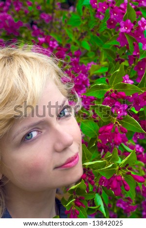 Beautiful girl face arounf the res flowers