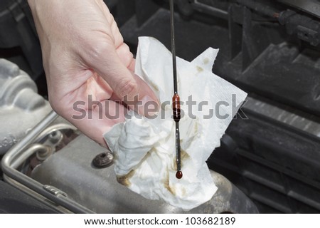 Driver checks the oil of his car