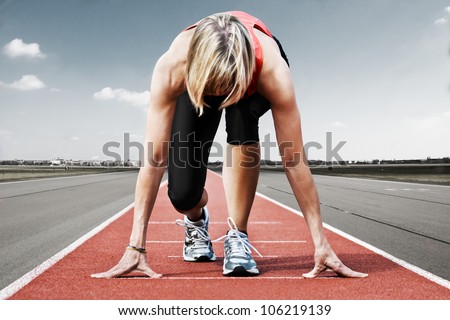 Female sprinter waiting for the start on an airport runway