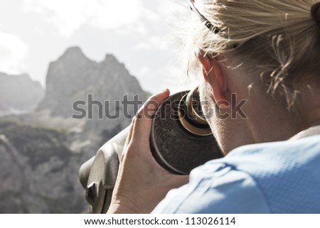 Woman looks through telescope