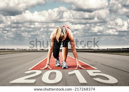 Female sprinter waiting for the start on an airport runway.In the foreground perspective view of the  date 2015.