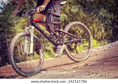 Shot of mountain bike rider with leg prosthesis riding downhill