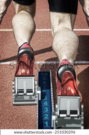 Top view of a male short track runner in the blocks. Desaturated hard colors and with own design replaced running shoes and start block are underlining the illustration effect of the photo.