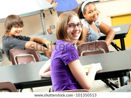 Happy teenage middle school or highschool students in class.