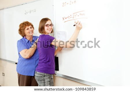 Math student and teacher working problems on the white board, with blank whiteboard space for text.