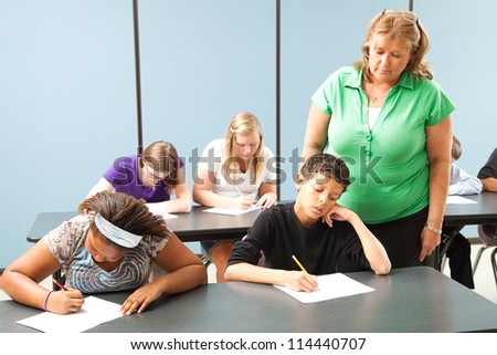 Teacher supervising students who are taking a standardized achievement test.