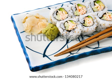 Japanese food - california roll served with wasabi and ginger.  White background
