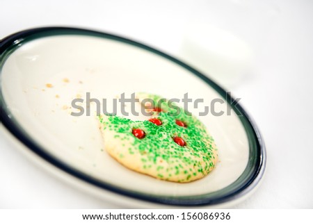 Christmas cookie missing a bite and milk left for Santa Claus.  Shallow depth of field.