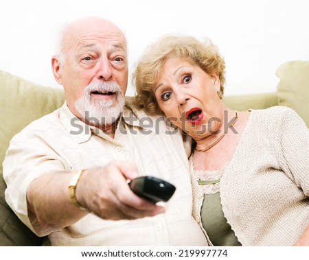 Senior Couple shocked by what they\'re watching on tv.