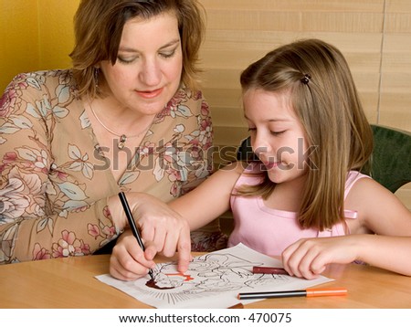 A woman teaching a little girl in Sunday School.