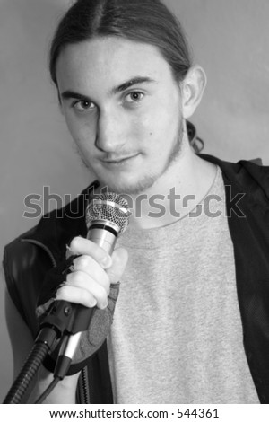 The lead singer of a teen-aged rock band in black and white