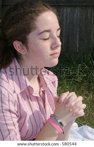 stock photo A cute teen girl praying toward heaven