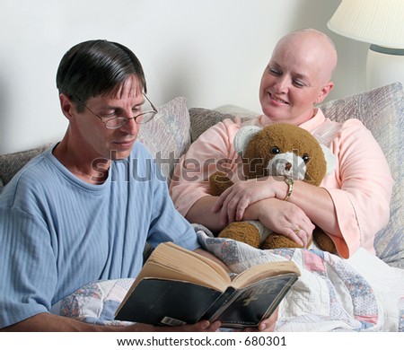 A man volunteering to read the bible to a cancer patient. (focus is on the woman\'s face)