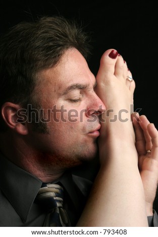 stock photo A handsome man kissing a woman's foot