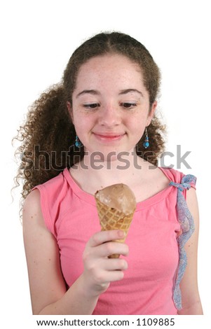 stock photo A cute teen girl eating a chocolate ice cream cone Isolated