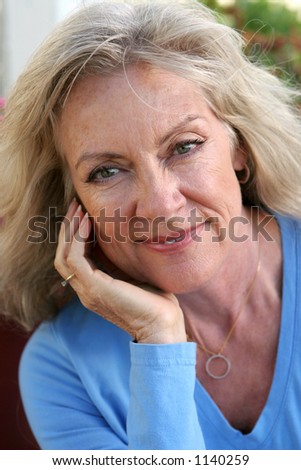 stock photo A beautiful mature blond woman relaxed and confident