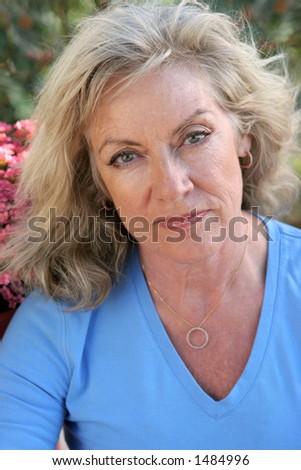 A beautiful middle-aged blond woman worried about her future.