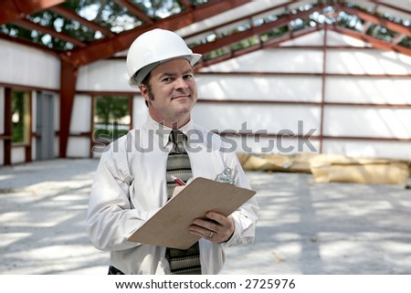 A construction inspector satisfied with his inspection of a steel framed building.