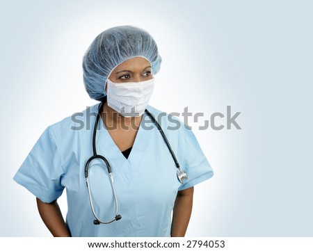 A doctor in surgical scrubs with hairnet and mask.  Isolated with room for text.