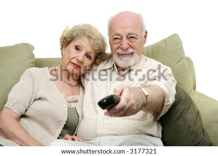 Seniors watching television together and switching channels.  White background.