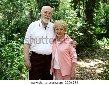 Portrait of a good looking, active senior couple taking a walk in the park.