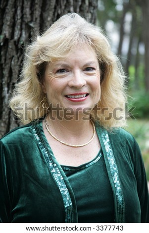 Outdoor portrait of a pretty fifty year old blond woman.