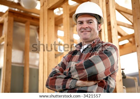 A handsome, friendly construction worker on the job site.  Authentic construction worker on actual construction site.