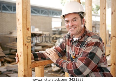 A friendly, smiling construction worker on the job.   Authentic construction worker on actual construction site.