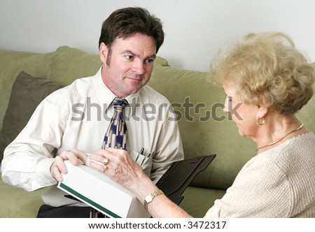 A sympathetic counselor offering an upset client a tissue.