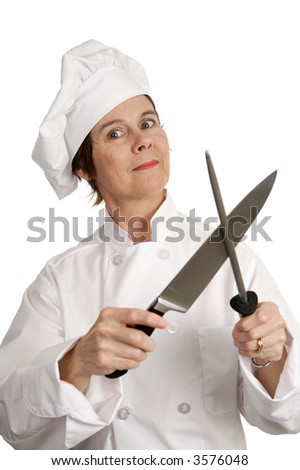 A crazy looking chef sharpening her butcher knife.  Isolated on white.