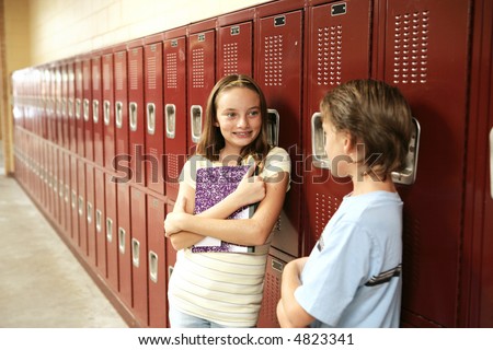 A cute school girl talking to a boy outside her locker.  Lockers are textured.  May appear as noise or artifacts at 100%.