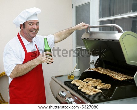 A happy smiling cook making dinner on his barbecue grill.