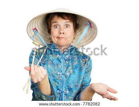 Tourist having trouble figuring out her chopsticks.  Isolated on white.