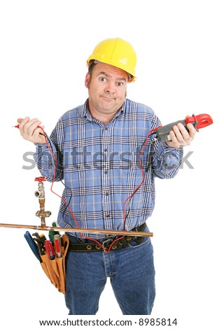Electrician confused by a plumbing project.  He\'s holding a voltage meter which is useless on a plumbing pipe.  Isolated on white.