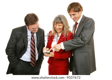 Business team enjoying a handheld electronic game.  Isolated on white.