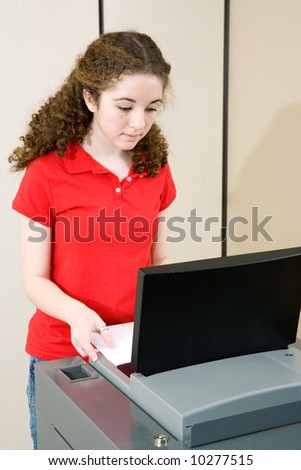 Young woman voting on new optical scan machine used in Florida.