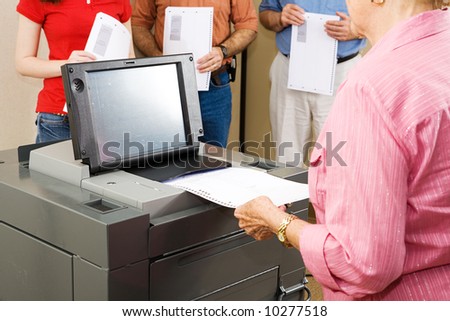 Closeup of a woman feeding her ballot into Florida\'s new optical scanner machine.